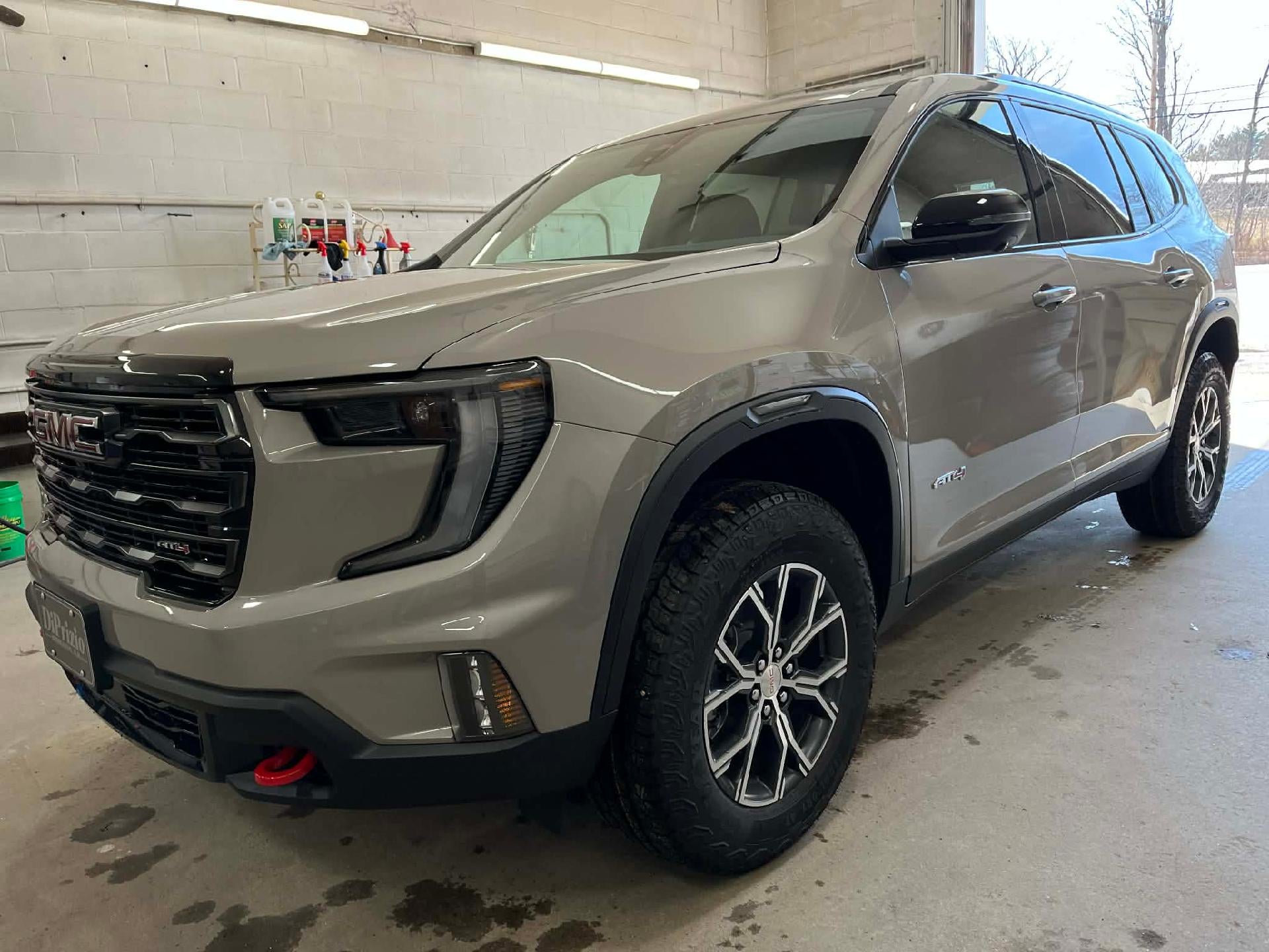 2026 GMC Acadia AT4 in Riverstone Metallic — front three-quarter view