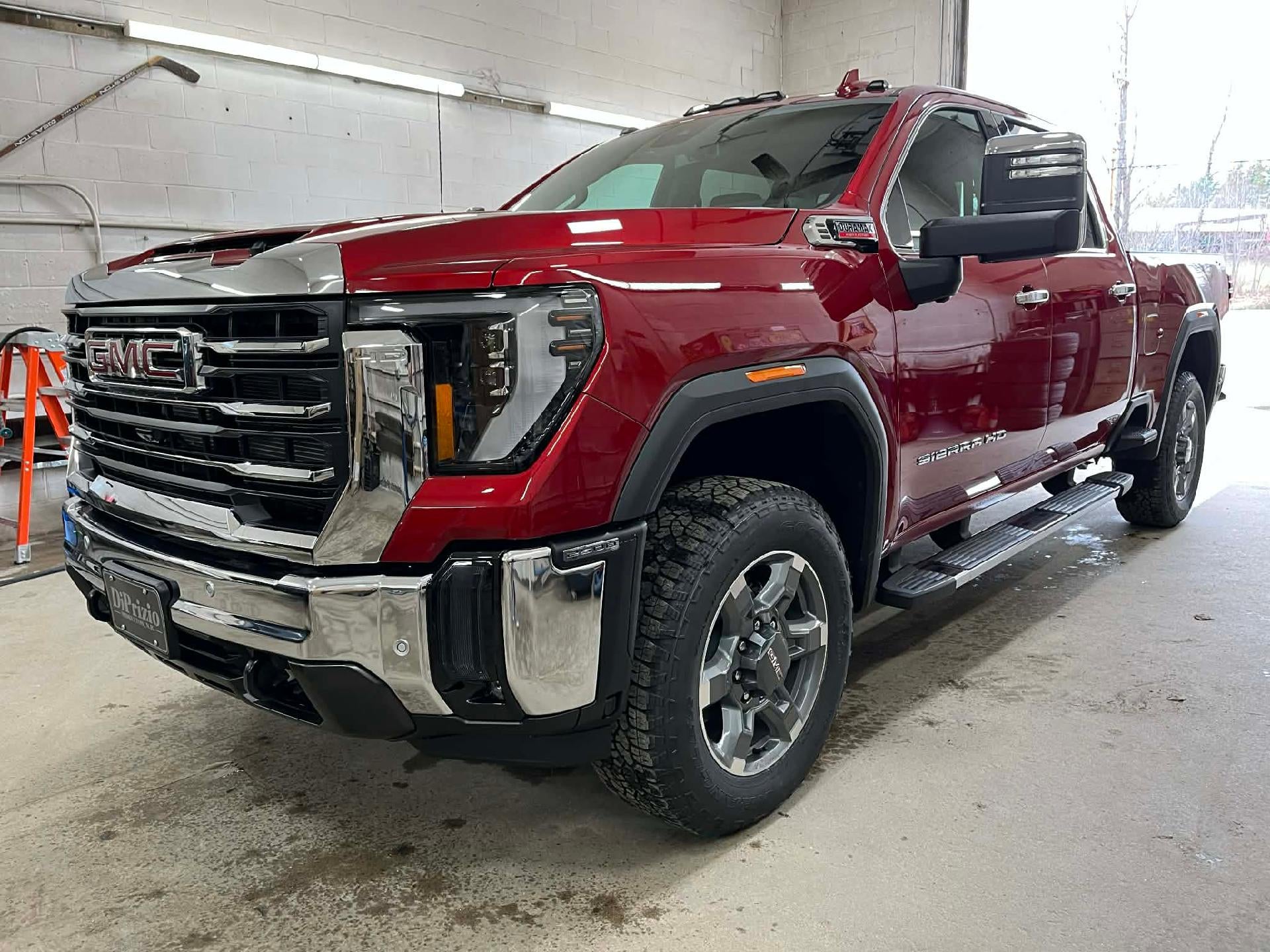 2026 GMC Sierra 2500 HD SLT in Volcanic Red Tintcoat — front three-quarter view